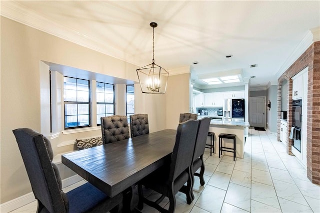 dining room with visible vents, baseboards, marble finish floor, crown molding, and a chandelier