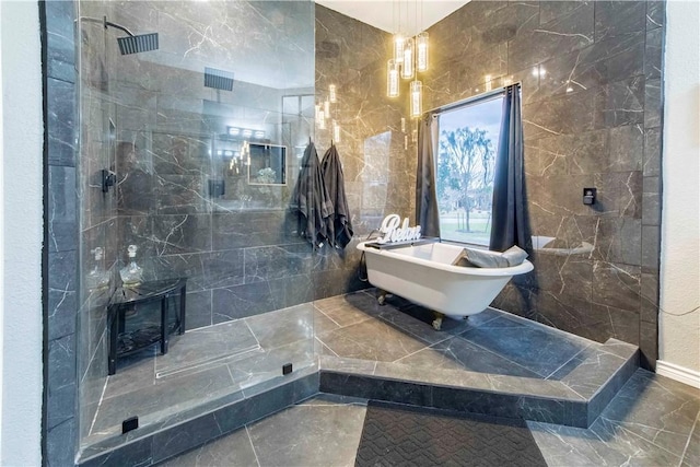 bathroom featuring a soaking tub, tile walls, and a walk in shower