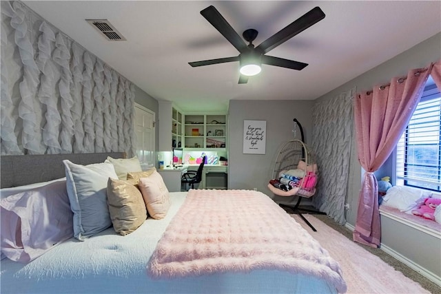 bedroom featuring a ceiling fan, baseboards, visible vents, and carpet flooring