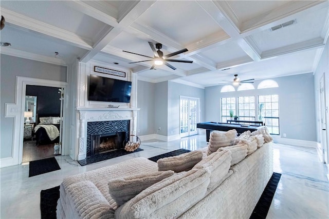 living area with baseboards, coffered ceiling, visible vents, and a healthy amount of sunlight