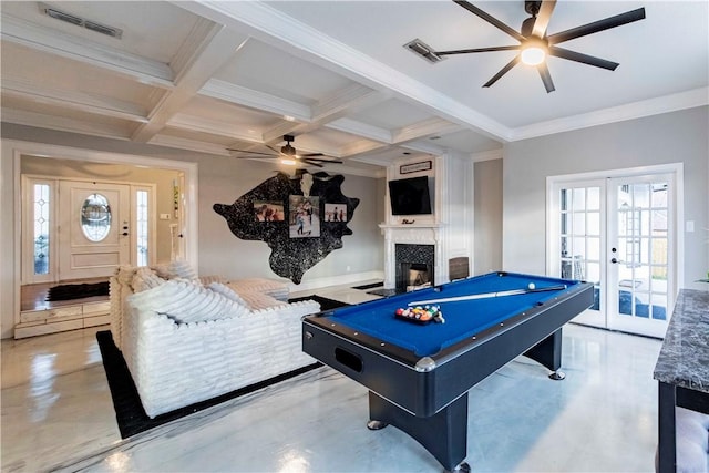 game room featuring coffered ceiling, a glass covered fireplace, ornamental molding, french doors, and beam ceiling