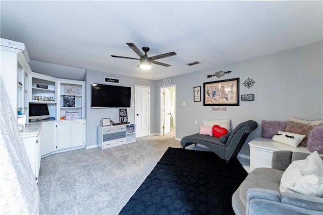 living room featuring baseboards, visible vents, a ceiling fan, and light colored carpet