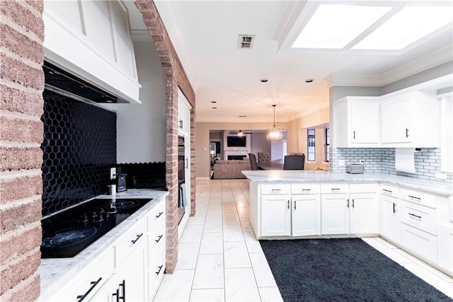 kitchen with black electric stovetop, a peninsula, visible vents, open floor plan, and range hood