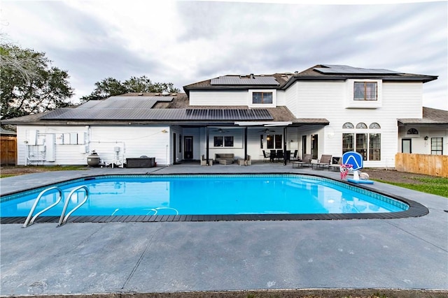 outdoor pool with a patio area, ceiling fan, and fence