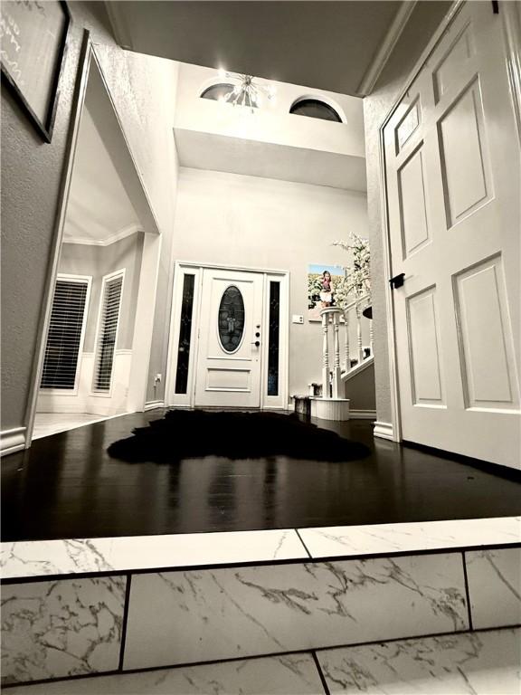 foyer with a high ceiling and wood finished floors