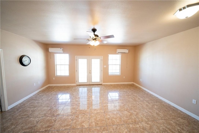 2033 Briarwood Dr, Corpus Christi, TX 78412 - empty room featuring a wall mounted AC, ceiling fan, and french doors