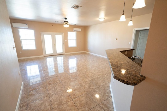 2033 Briarwood Dr, Corpus Christi, TX 78412 - spare room with ceiling fan, a wall mounted air conditioner, light tile patterned flooring, and french doors