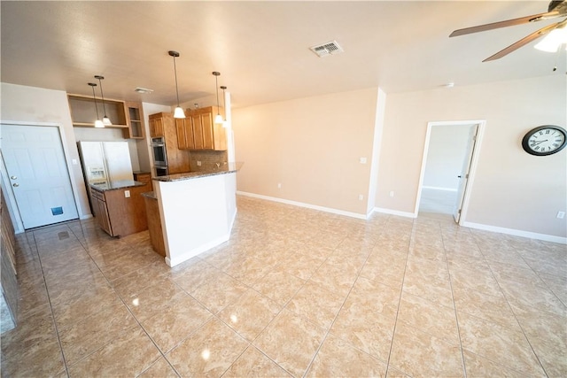 2033 Briarwood Dr, Corpus Christi, TX 78412 - kitchen featuring ceiling fan, open floor plan, decorative backsplash, and dark stone countertops