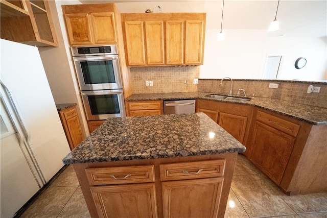 2033 Briarwood Dr, Corpus Christi, TX 78412 - kitchen featuring appliances with stainless steel finishes, tasteful backsplash, a peninsula, and light tile patterned floors