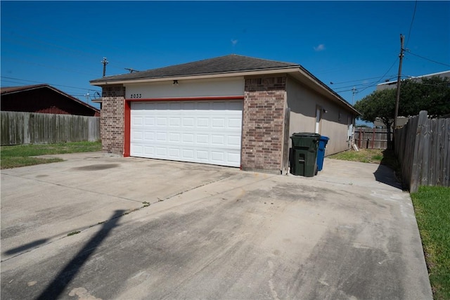 2033 Briarwood Dr, Corpus Christi, TX 78412 - view of side of home with brick siding, a garage, and driveway