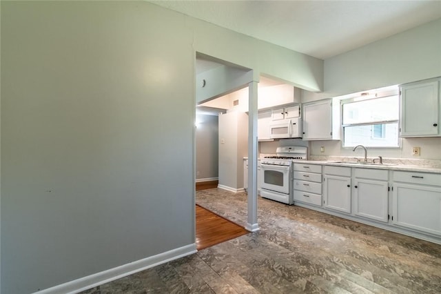 5933 Lucille Dr, Corpus Christi, TX 78412 - kitchen featuring white appliances, light countertops, and white cabinets