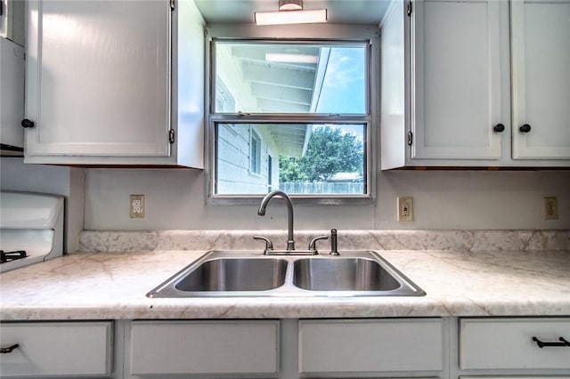 5933 Lucille Dr, Corpus Christi, TX 78412 - kitchen featuring light countertops and white cabinetry
