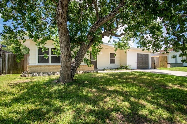 5933 Lucille Dr, Corpus Christi, TX 78412 - view of property hidden behind natural elements with brick siding, concrete driveway, and a garage