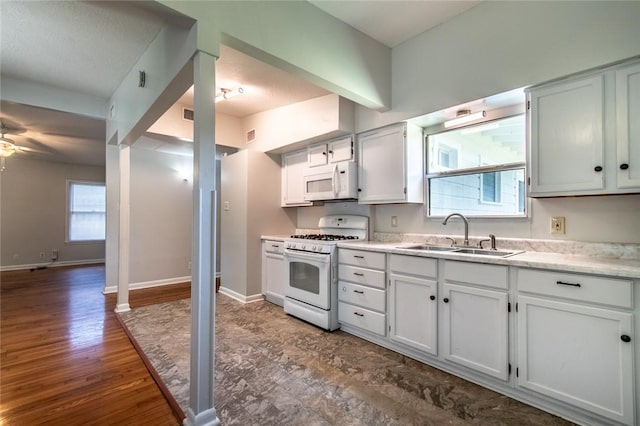 5933 Lucille Dr, Corpus Christi, TX 78412 - kitchen with white appliances, ceiling fan, dark wood-style flooring, and white cabinetry