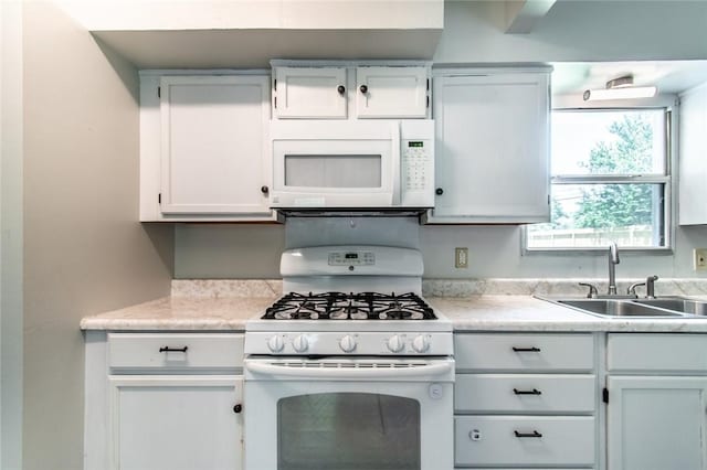 5933 Lucille Dr, Corpus Christi, TX 78412 - kitchen featuring white appliances, light countertops, and white cabinetry