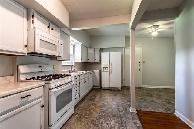 5933 Lucille Dr, Corpus Christi, TX 78412 - kitchen with white appliances, ceiling fan, and light countertops
