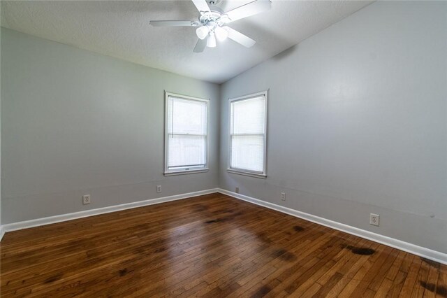 5933 Lucille Dr, Corpus Christi, TX 78412 - unfurnished room featuring dark wood finished floors, vaulted ceiling, and ceiling fan