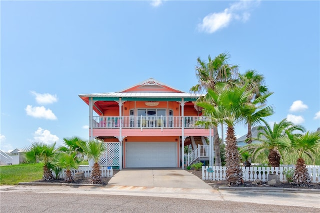 coastal home featuring a garage and a porch