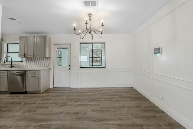 kitchen featuring dishwasher, a wealth of natural light, gray cabinets, and visible vents