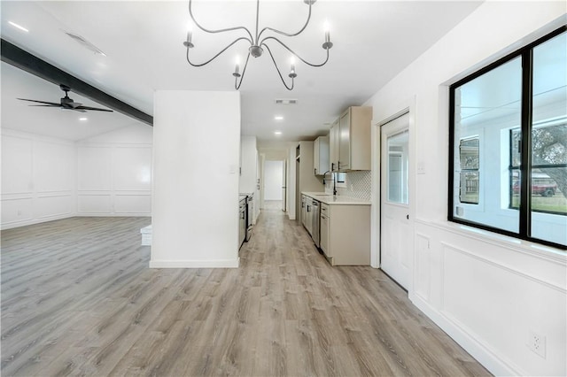 kitchen with backsplash, visible vents, a decorative wall, and light countertops