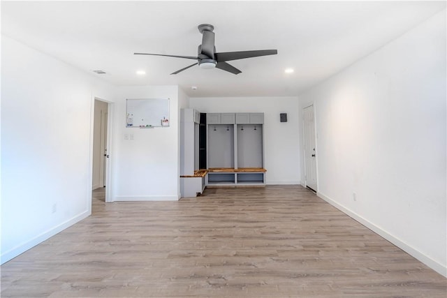 unfurnished room featuring light wood-style flooring, baseboards, and recessed lighting