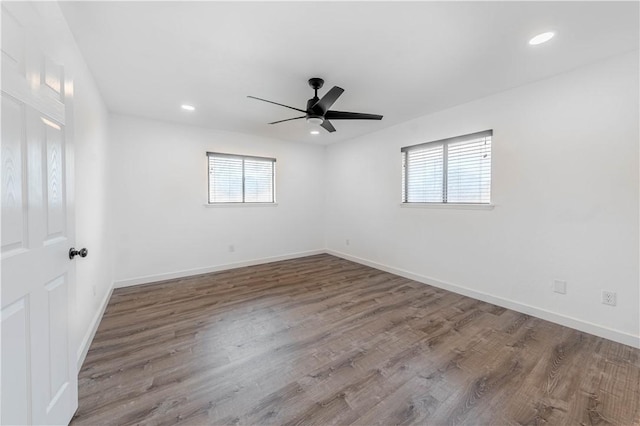 unfurnished room with recessed lighting, baseboards, and wood finished floors