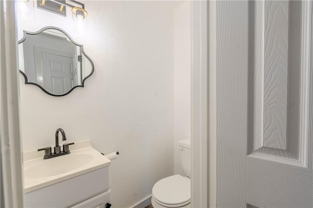 bathroom with toilet and vanity