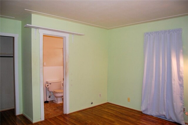 201 S Alta Vista St, Beeville, TX 78102 - unfurnished bedroom featuring wood finished floors and connected bathroom