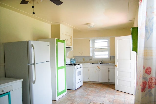 201 S Alta Vista St, Beeville, TX 78102 - kitchen with white appliances, light countertops, ceiling fan, and white cabinets