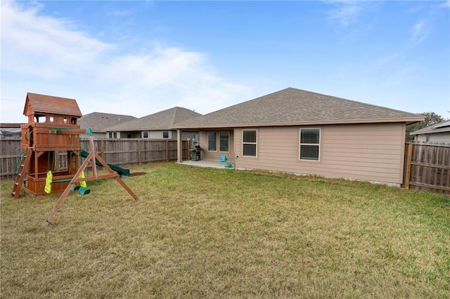 back of property featuring a playground, a yard, and a patio area