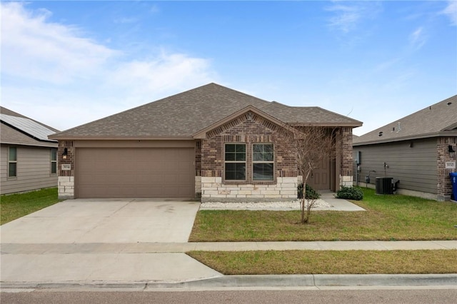 ranch-style house with a garage, central air condition unit, and a front lawn