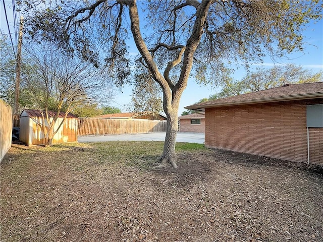 4638 Wilma Dr, Corpus Christi, TX 78412 - view of yard featuring an outdoor structure, fence, and a shed