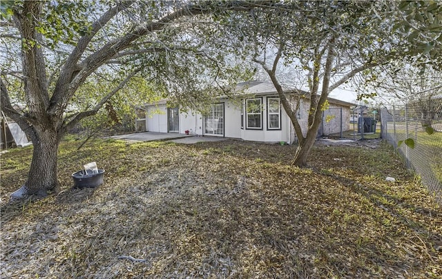 view of front of house featuring a patio area and fence