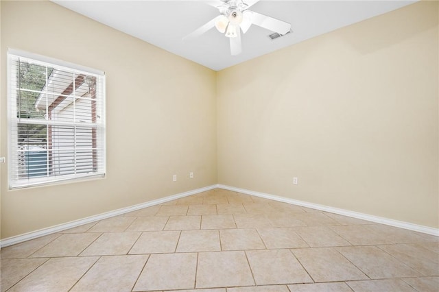 tiled empty room with ceiling fan