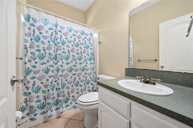 bathroom featuring tile patterned flooring, vanity, and toilet