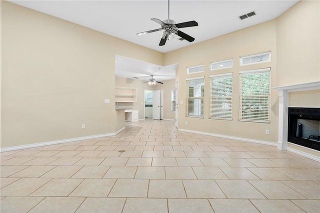 unfurnished living room featuring ceiling fan