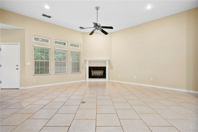 unfurnished living room with ceiling fan and light tile patterned flooring