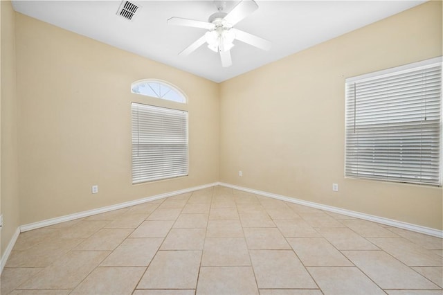 spare room featuring ceiling fan and light tile patterned flooring