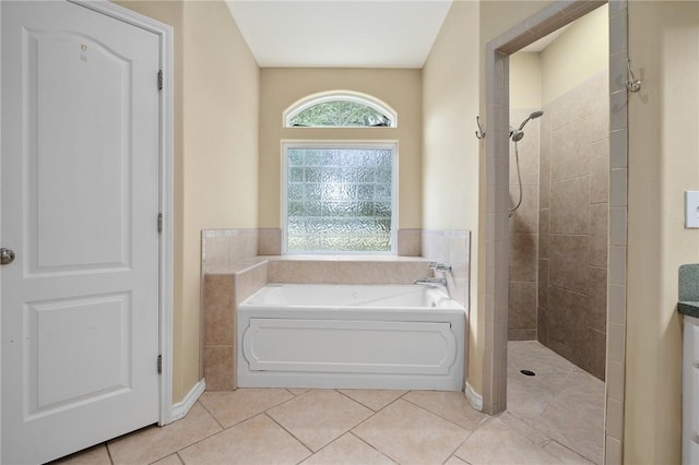 bathroom featuring tile patterned flooring and shower with separate bathtub