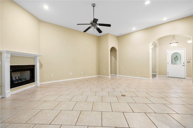 unfurnished living room featuring ceiling fan