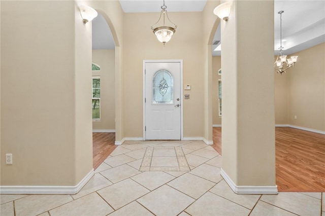 entrance foyer featuring light tile patterned floors and a chandelier