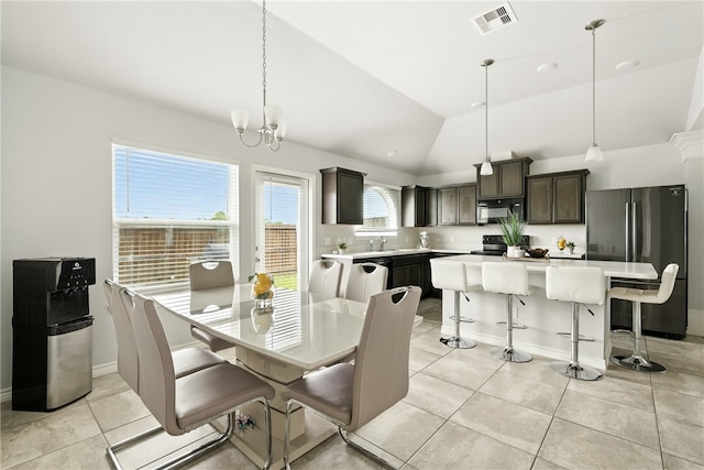6758 Mikayla St, Corpus Christi, TX 78413 - dining space with light tile patterned flooring, vaulted ceiling, and a chandelier