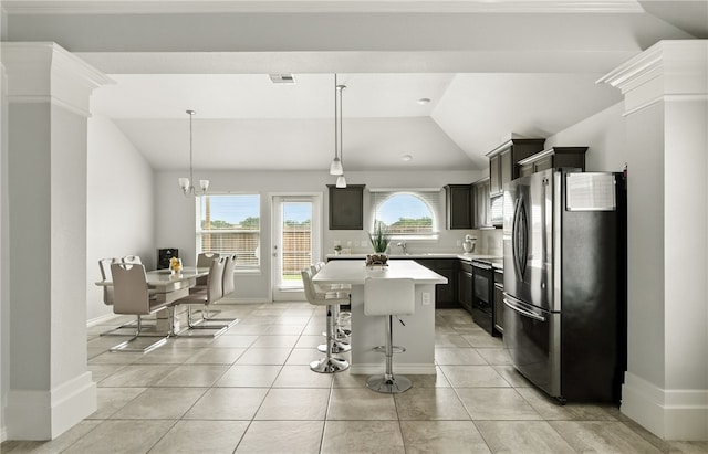 6758 Mikayla St, Corpus Christi, TX 78413 - kitchen featuring freestanding refrigerator, lofted ceiling, light countertops, electric range, and a center island