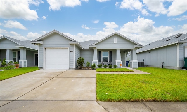 6758 Mikayla St, Corpus Christi, TX 78413 - view of front of property featuring covered porch, a garage, concrete driveway, and a front lawn