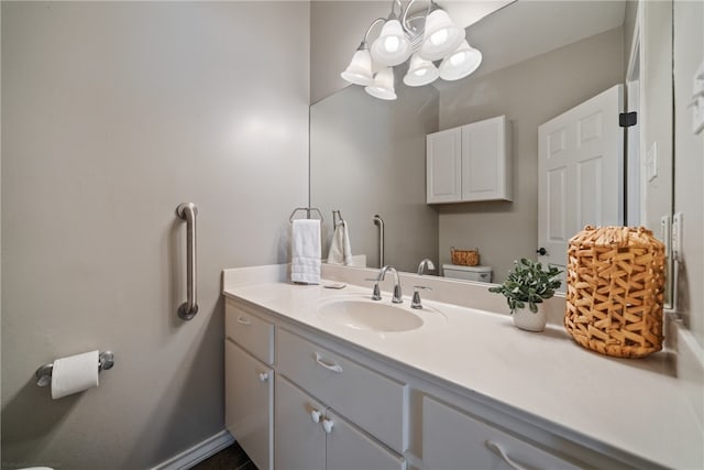 bathroom featuring vanity and a notable chandelier