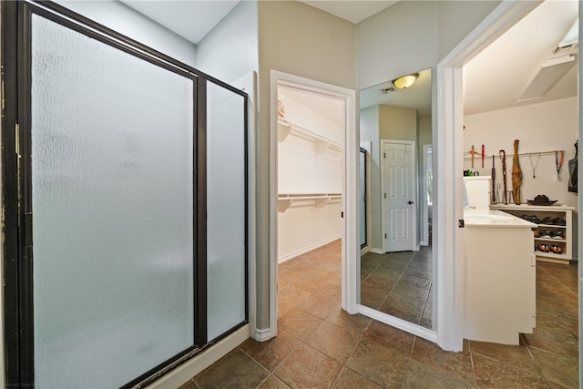 bathroom with a shower with door and vanity