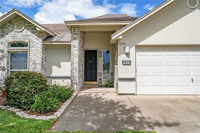 view of exterior entry featuring a garage