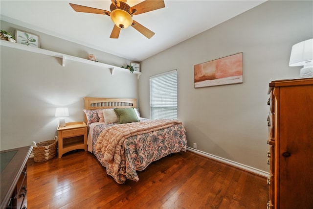 bedroom with ceiling fan and dark hardwood / wood-style floors