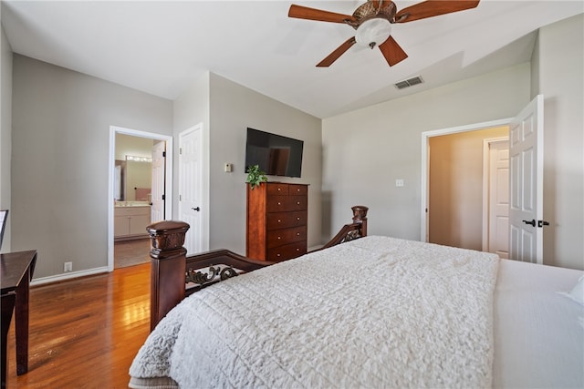 bedroom with connected bathroom, hardwood / wood-style flooring, and ceiling fan