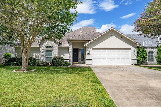 ranch-style house featuring a garage and a front lawn